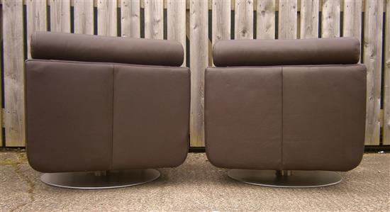 A pair of Natuzzi leather swivel armchairs W.77cm